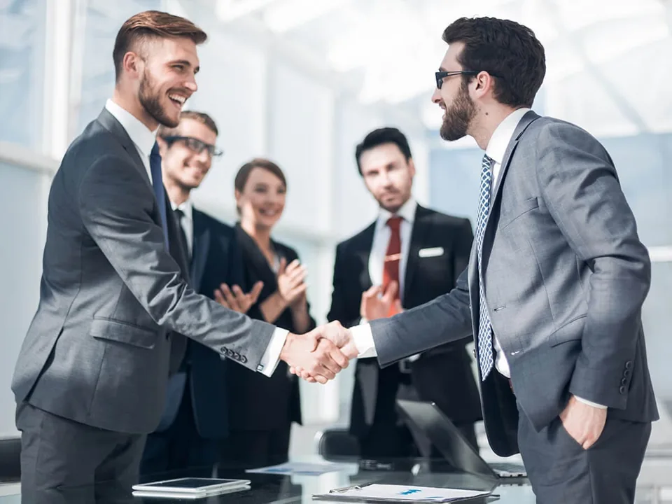 Professionals shaking hands at a business meeting